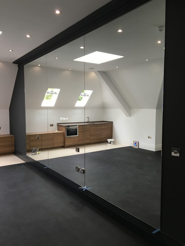 Frameless glass partition in loft conversion by Tulse Hill glaziers