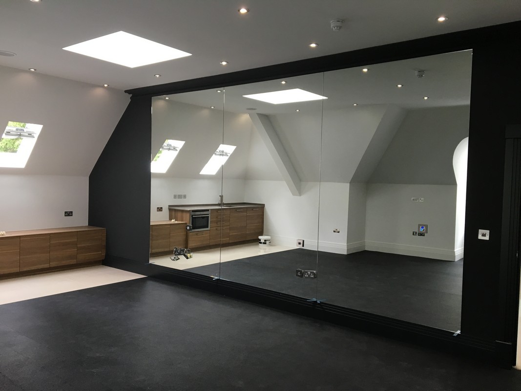 Frameless glass wall dividing loft conversion in Tulse Hill